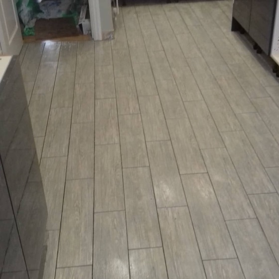 Wood effect plank porcelain laid across a bathroom floor